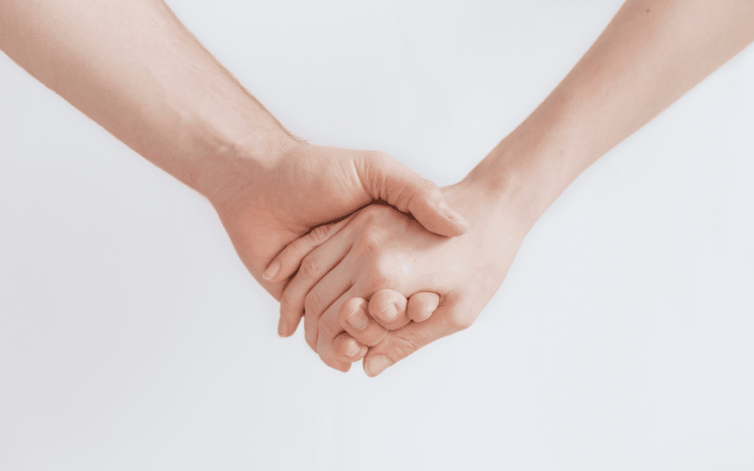 Two hands holding each other